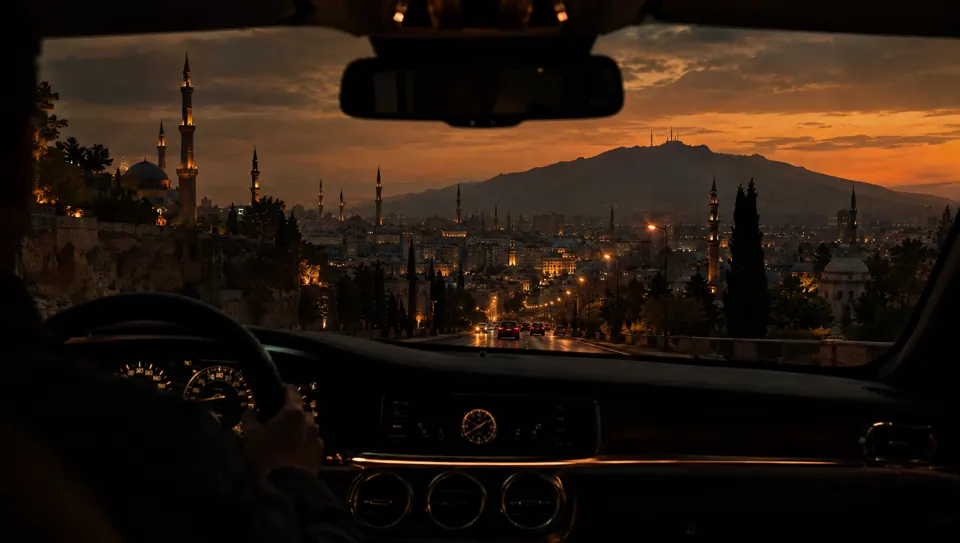 City skyline at dusk seen through a car windshield